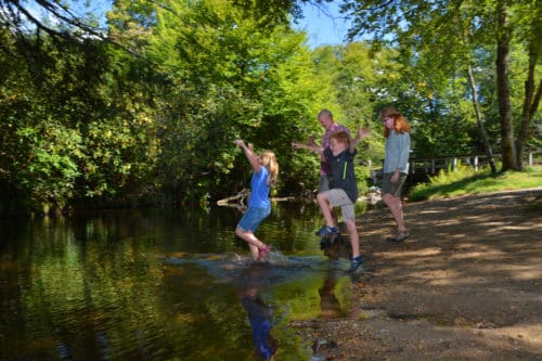 family wading in the stream on the blue ridge parkway