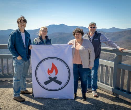 BRTDA staff stand with Unity Blaze banner for Black Folks Camp Too